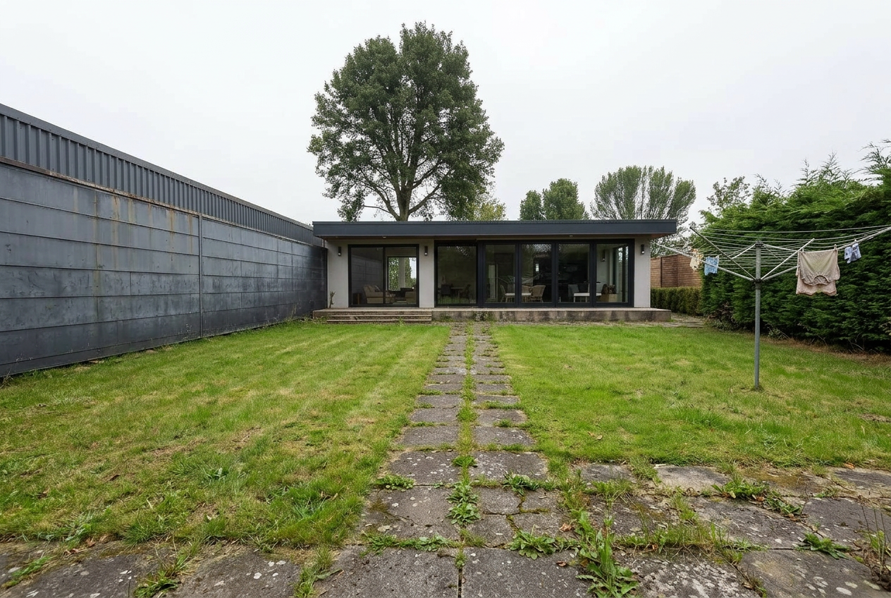 The existing East Sheen garden before works — crazy paving and overgrown boundary